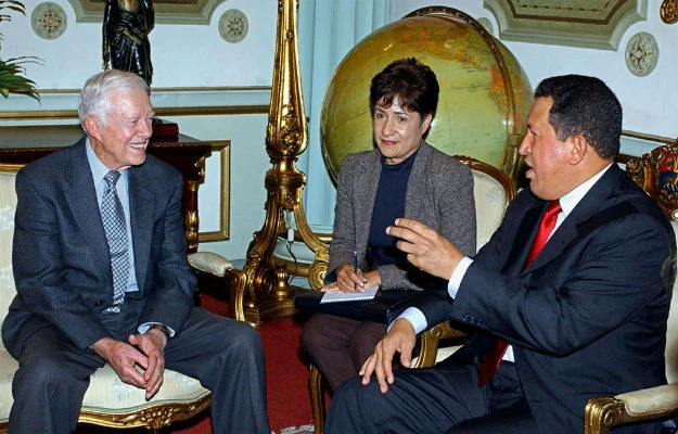 A group of men sitting in chairs Description automatically generated with low confidence
