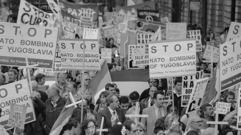 A group of people marching with signs

AI-generated content may be incorrect.