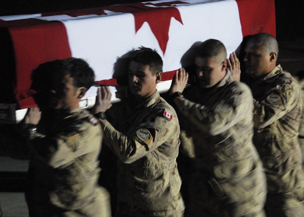 A group of soldiers carrying a coffin

AI-generated content may be incorrect.