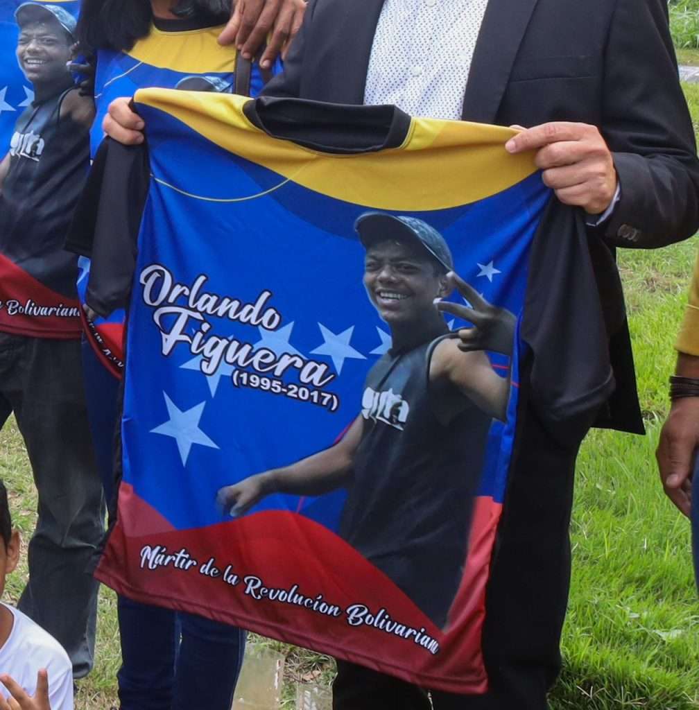 A person holding a shirt with a picture of a person and a child
AI-generated content may be incorrect.