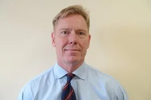 A person in a blue shirt and tie
AI-generated content may be incorrect.