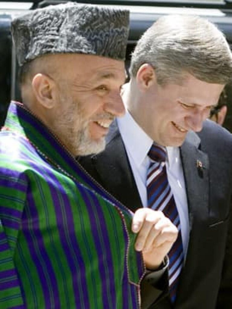 A person in a hat smiling next to another person

AI-generated content may be incorrect.