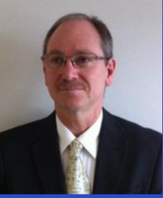 A person in a suit and tie

Description automatically generated