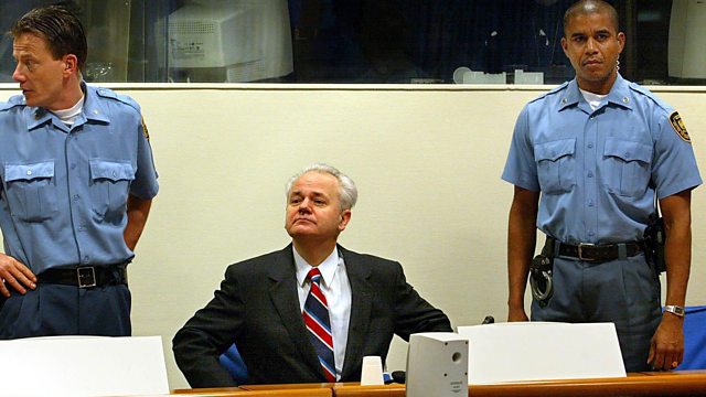 A person in a suit and tie with police officers standing behind him

AI-generated content may be incorrect.