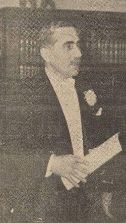 A person in a suit holding a paper

AI-generated content may be incorrect.