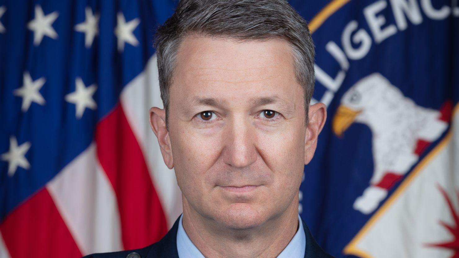 A person in a suit in front of a flag

AI-generated content may be incorrect.