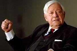 A person in a suit raising his hand

AI-generated content may be incorrect.