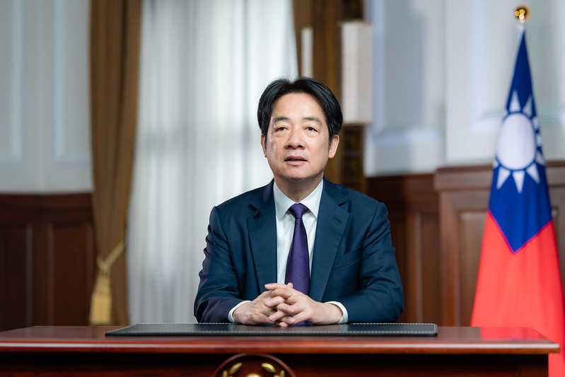 A person in a suit sitting at a desk
AI-generated content may be incorrect.