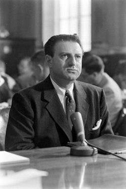 A person in a suit sitting at a desk

AI-generated content may be incorrect.