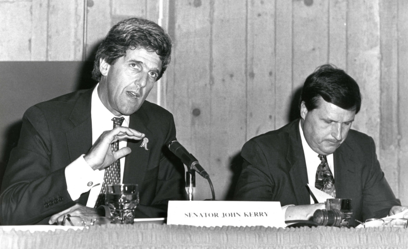 A person in a suit speaking to another person

AI-generated content may be incorrect.