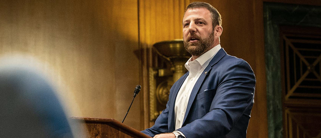 A person in a suit standing at a podium

AI-generated content may be incorrect.