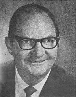 A person wearing glasses and a suit

AI-generated content may be incorrect.