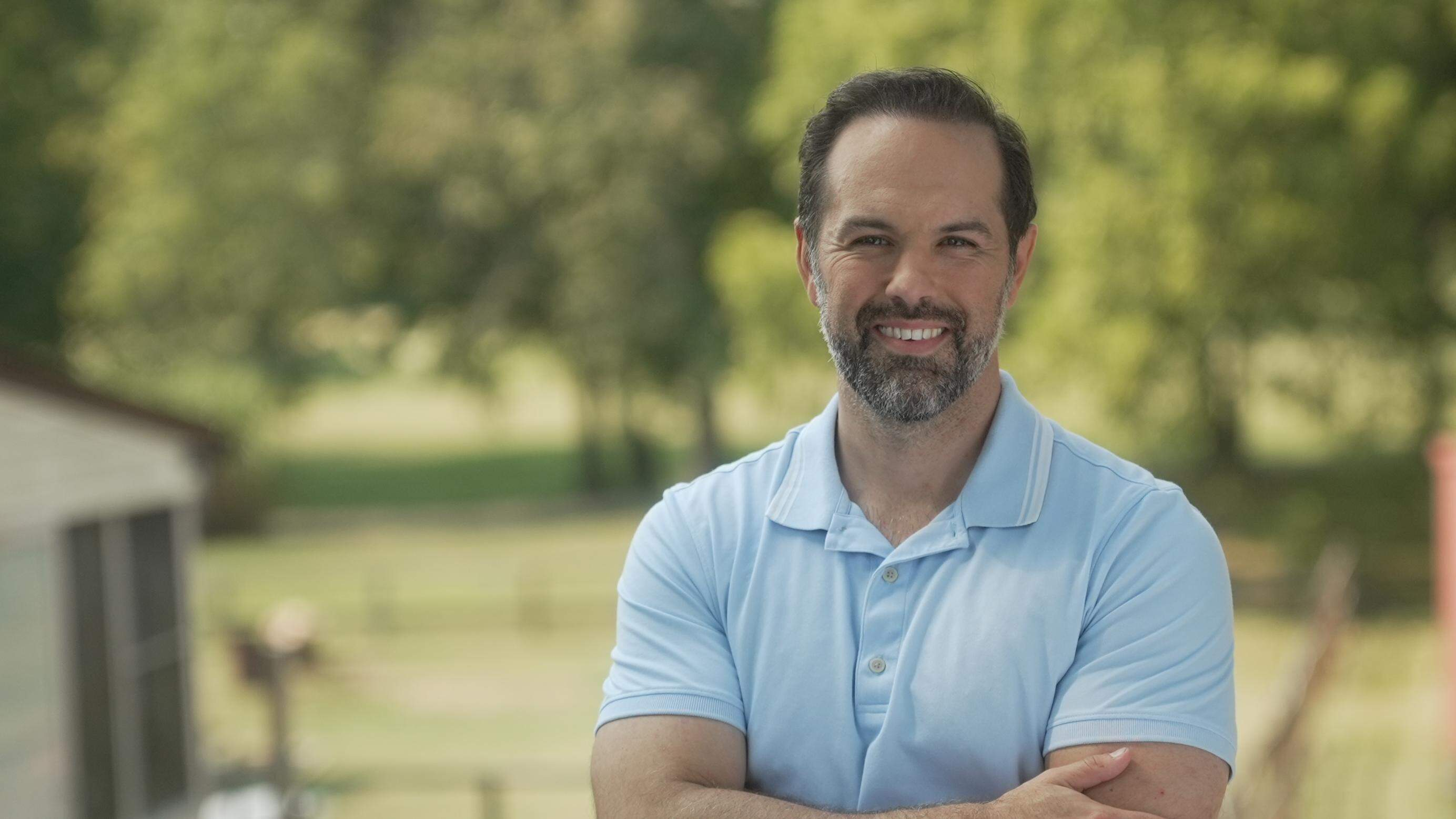 A person with a beard and mustache wearing a blue polo shirt

AI-generated content may be incorrect.