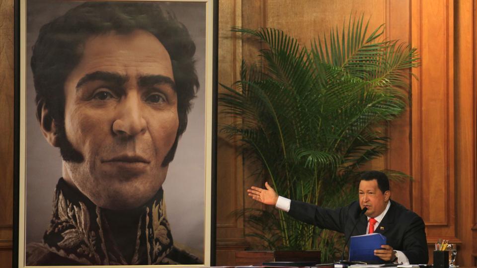 Venezuela's late President Hugo Chavez unveils a photograph-like portrait of Venezuela's independence hero Simon Bolivar on the 229th anniversary of Bolivar's birth at Miraflores Presidential Palace in Caracas, Venezuela, Tuesday, July 24, 2012.