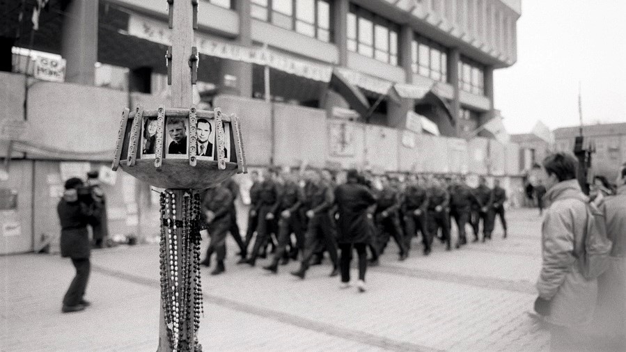 A group of people marching in a line
AI-generated content may be incorrect.