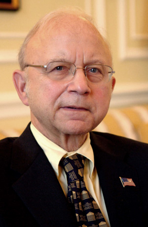 A person wearing glasses and a suit

AI-generated content may be incorrect.