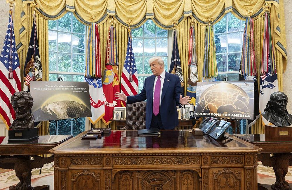 Donald Trump speaks with officials and staff in the Oval Office during the announcement of the Golden Dome missile defense system, Tuesday, May 20, 2025