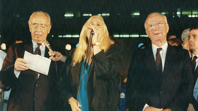 L to R: Peres with singer Shulamit Aloni and Rabin singing 'A Song for Peace' at the peace rally in which Rabin was murdered (Photo: Michael Kremer)