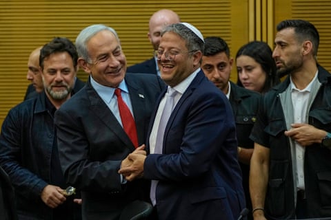 Netanyahu and Ben-Gvir hold hands and laugh together.