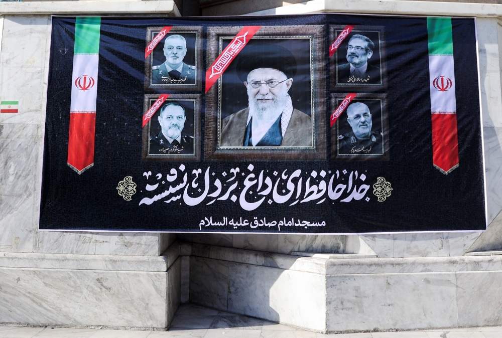 A banner in tribute to Iran's late Supreme Leader Ayatollah Ali Khamenei, after he was killed in Israeli and US strikes on Saturday, and other leaders who were killed amid the US-Israeli conflict with Iran, is displayed on a street in Tehran March 4, 2026. — Majid Asgaripour/Wana (West Asia News Agency) pic via Reuters
