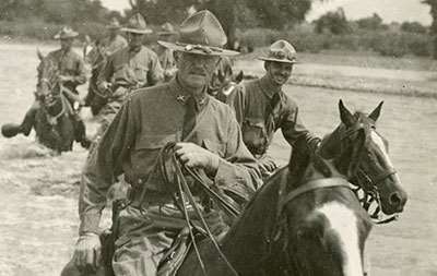 A group of men riding horses

AI-generated content may be incorrect.