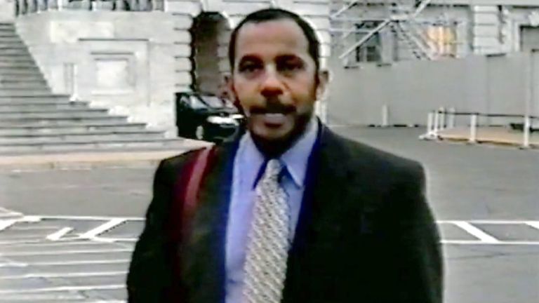 A person in a suit and tie

AI-generated content may be incorrect.