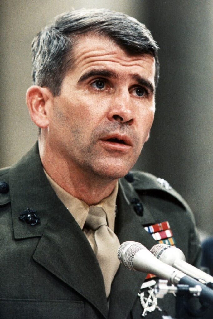 A person in military uniform speaking into microphones

AI-generated content may be incorrect.