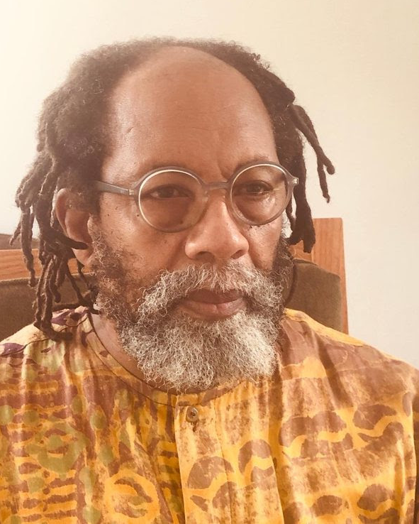 A person with dreadlocks and round glasses

AI-generated content may be incorrect.