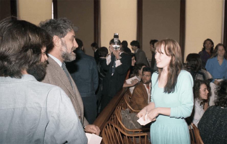 A group of people standing in a room

AI-generated content may be incorrect.