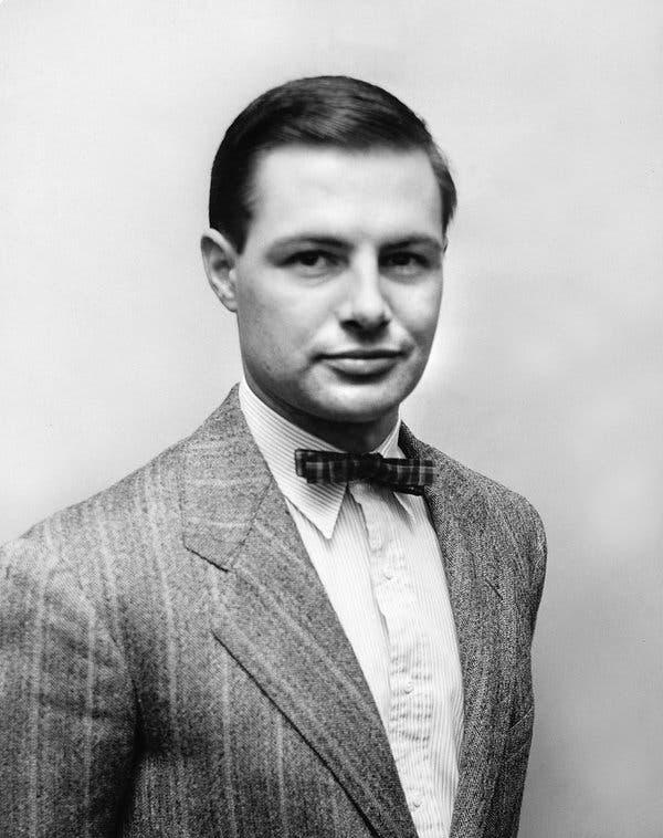 A person in a suit and bow tie

Description automatically generated