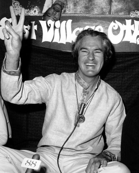 A person sitting on a couch holding up his hand

AI-generated content may be incorrect.