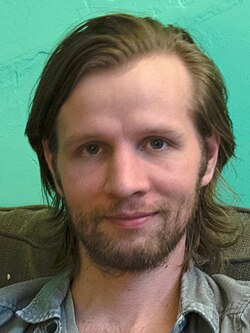 A person with a beard

AI-generated content may be incorrect.