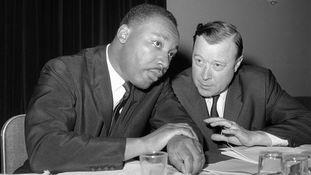 A black and white photo of men in suits

AI-generated content may be incorrect.