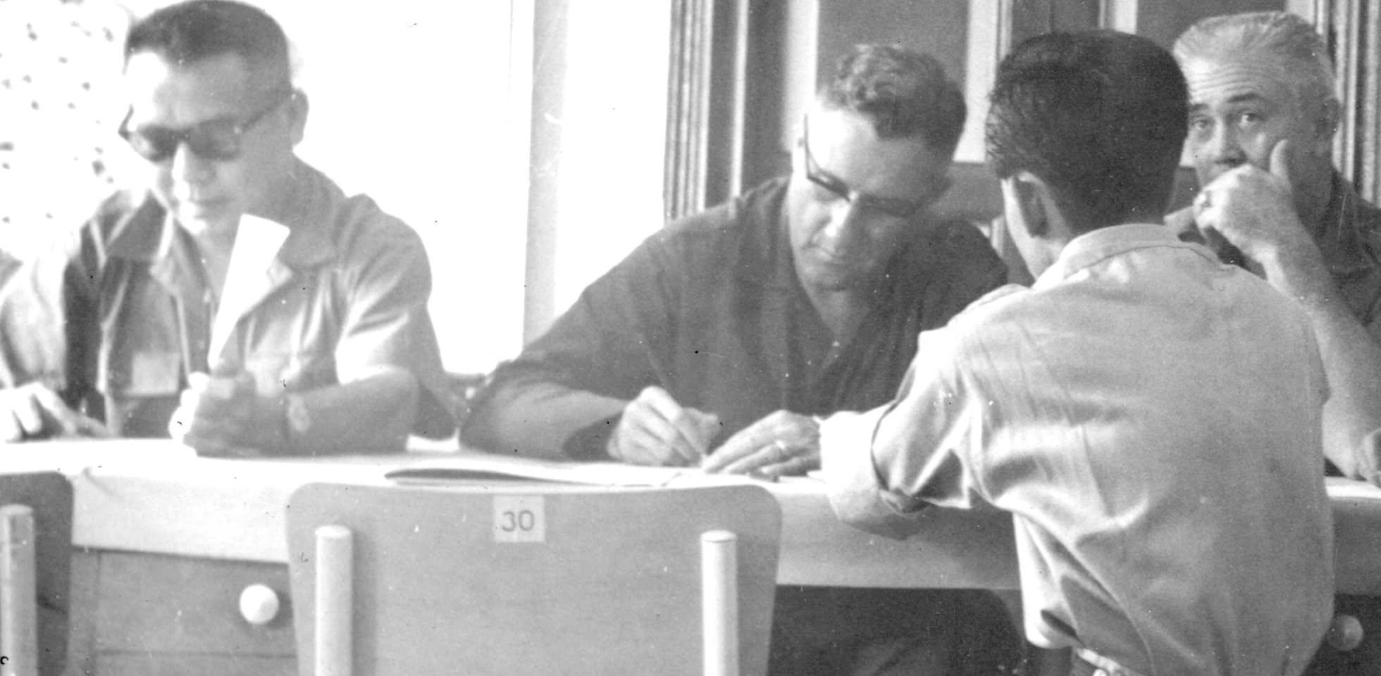 A group of men sitting at a table

AI-generated content may be incorrect.
