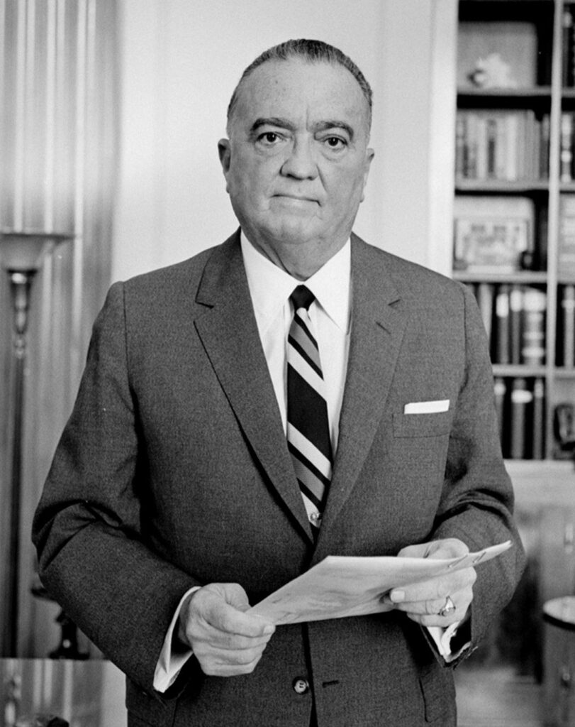 A person in a suit holding a paper

AI-generated content may be incorrect.