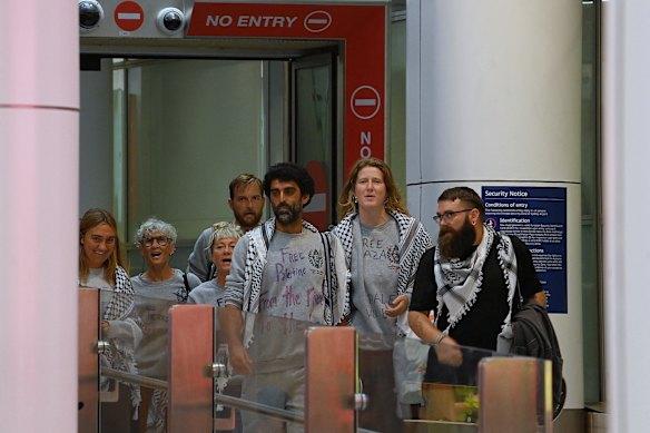 Global Sumud Flotilla participants arrive at Sydney International Airport on Monday. Left to right: Isla Lamont, Anny Mokotow, Zack Schofield, Juliet Lamont, Surya McEwen, Neve O’Connor and Sam Woripa Watson.
