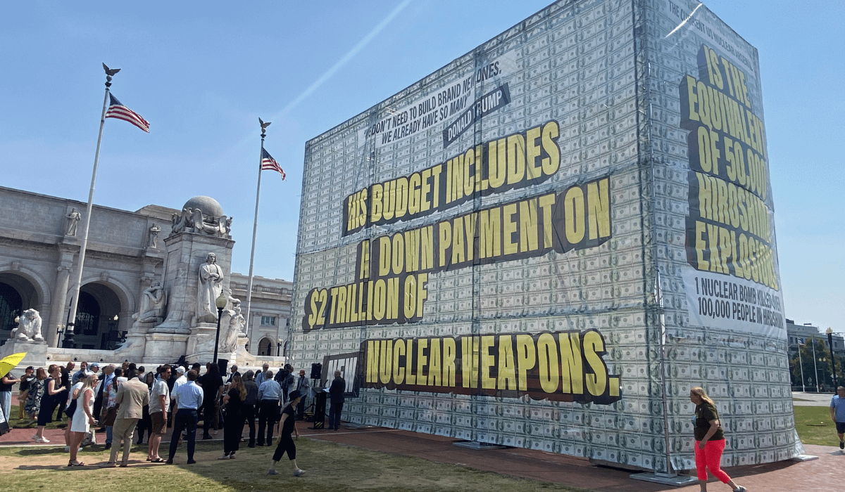 Sculpture of stacked billion-dollar bills in front of the Capitol building.