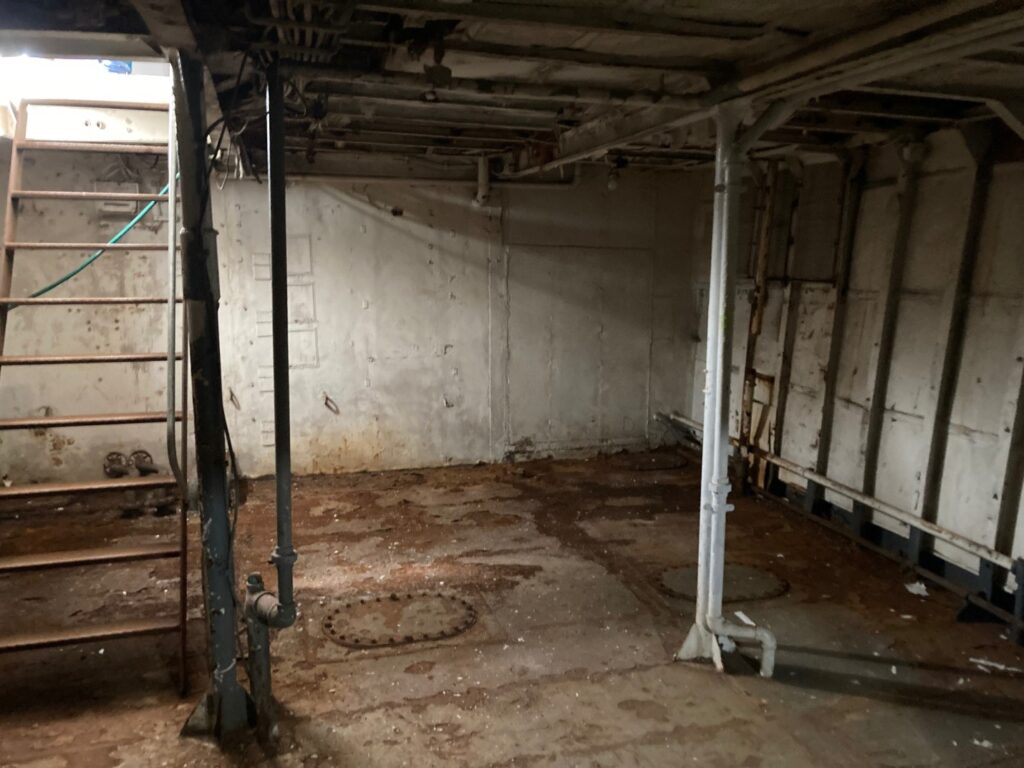 A dirty room with pipes and a ladder
AI-generated content may be incorrect.