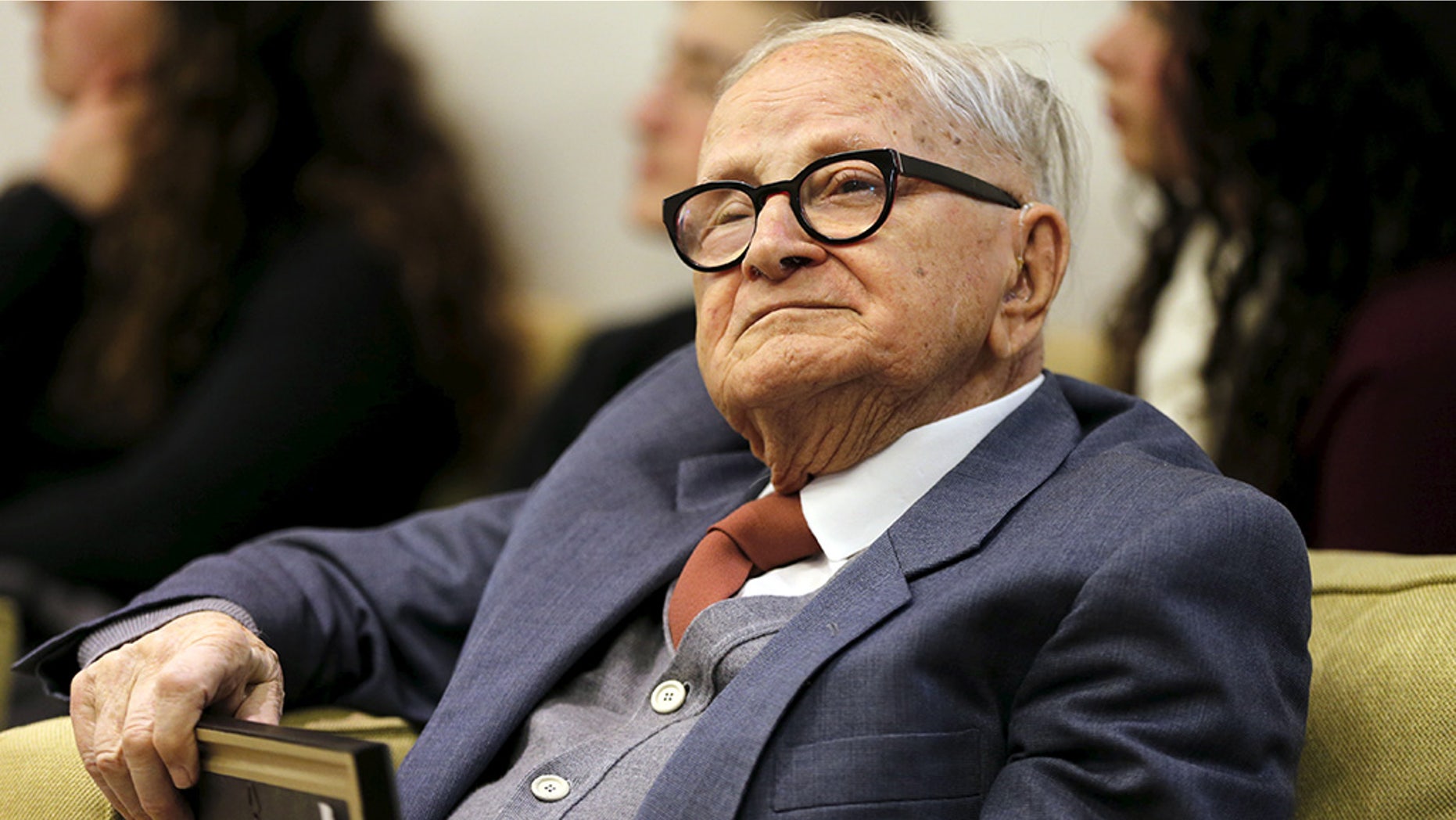 An old person in glasses and a suit
AI-generated content may be incorrect.