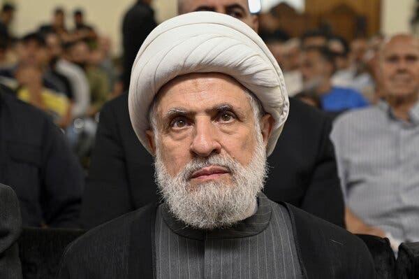 Naim Qassem is seen from the front.