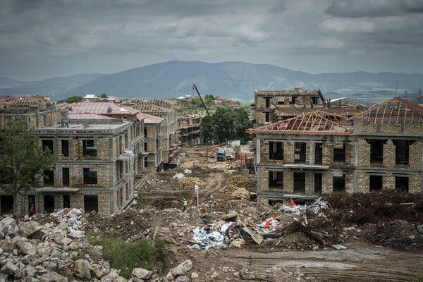 New buildings under construction. Mountains can be seen in the background.