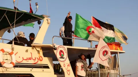 Reuters Crew interacts from aboard a boat, part of the Global Sumud Flotilla 