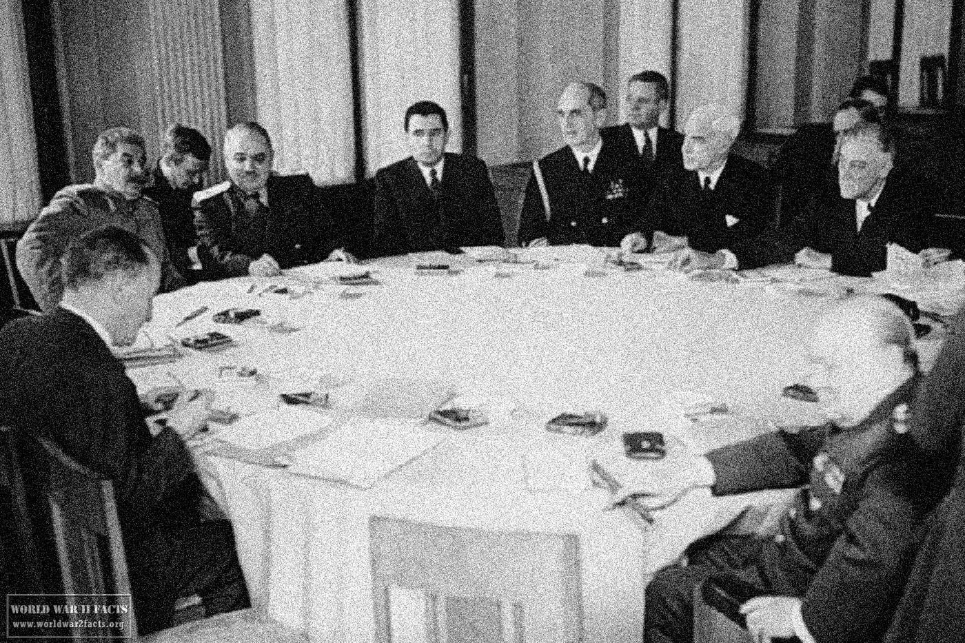 A group of men sitting around a round table

AI-generated content may be incorrect.