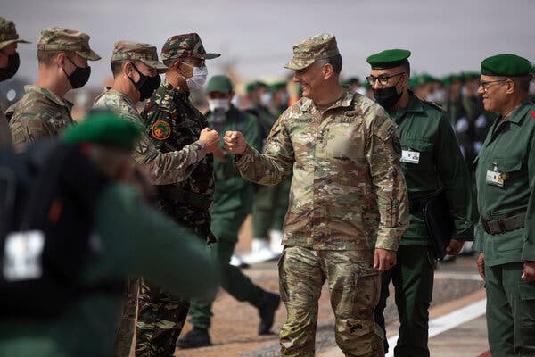 A group of people in military uniforms shaking hands
AI-generated content may be incorrect.
