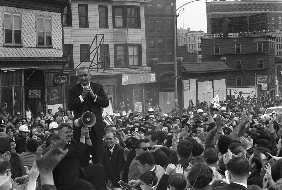 A person speaking into a megaphone in front of a crowd

AI-generated content may be incorrect.