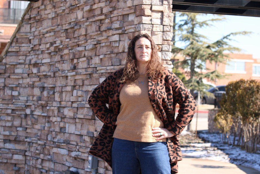 A person standing in front of a brick wall
AI-generated content may be incorrect.