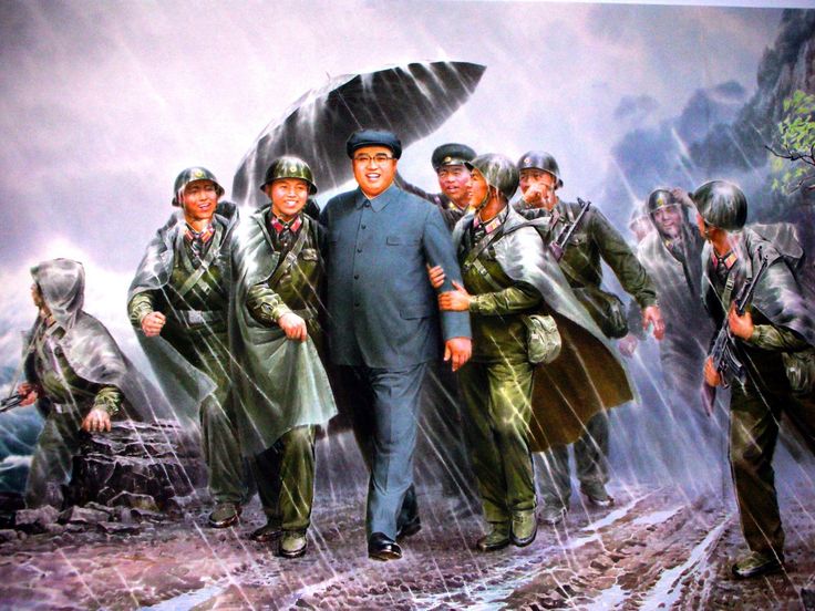 A person walking with a group of men in military uniforms
AI-generated content may be incorrect.