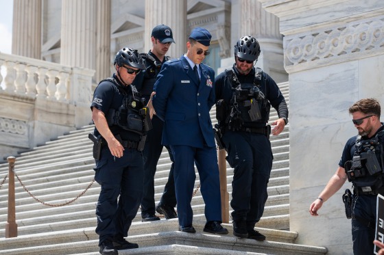 U.S. Air Force Major Jason Watson is arrested by police on the Capitol steps.