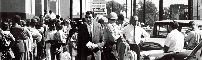 A person in a suit and tie walking down a sidewalk
AI-generated content may be incorrect.