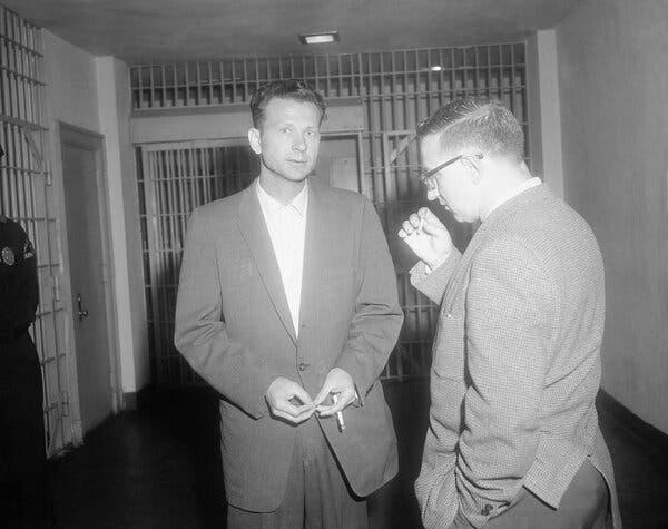 A person in a suit talking to another person

AI-generated content may be incorrect.